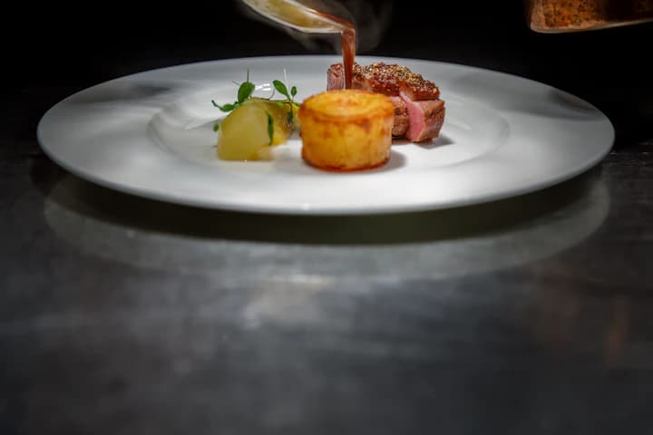 LSCAHM chefs at the pass during service in a working kitchen