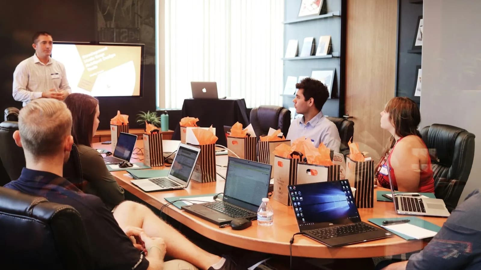 Business team collaborating around laptops in a London LSCT meeting room